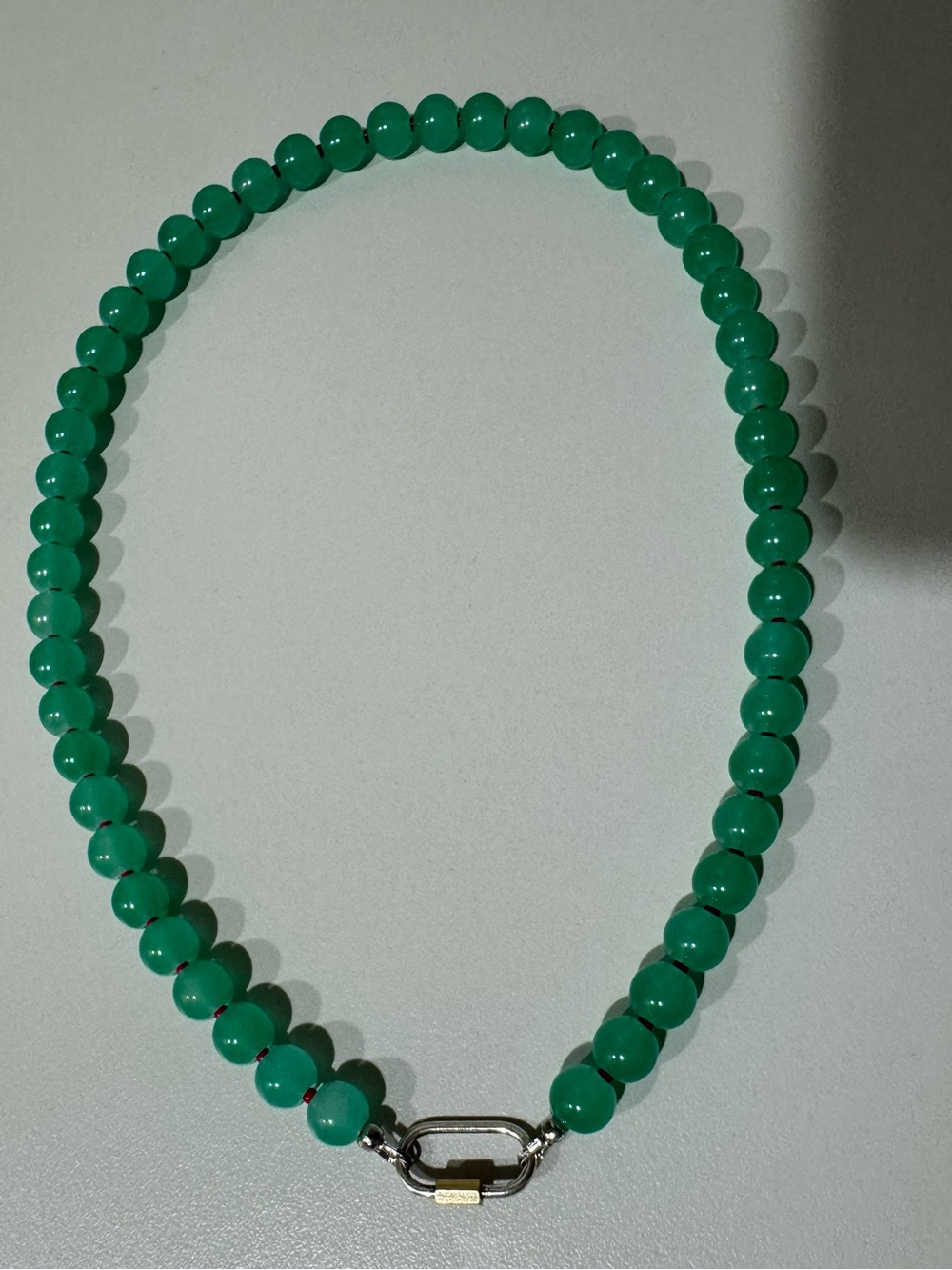 Green and red beaded necklace with carabiner clasp